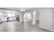Open-concept living area showcasing hardwood floors, arched entryways, and modern kitchen at 186 Dan River Dr, Spring Hill, FL 34606