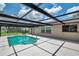 Beautiful pool area featuring a screened-in enclosure, providing a serene retreat for relaxation and enjoyment at 186 Dan River Dr, Spring Hill, FL 34606