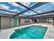 Relaxing screened-in pool area with ladder and ample sunlight, perfect for enjoying the outdoors at 186 Dan River Dr, Spring Hill, FL 34606