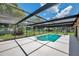 The pool is enclosed with screening and has ladder access on the end near the house for convenience at 186 Dan River Dr, Spring Hill, FL 34606