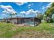 Exterior view of home with a screened-in pool area, showing the serene outdoor space with lush greenery at 186 Dan River Dr, Spring Hill, FL 34606