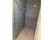 Bathroom shower stall with light-blue tiling and glass doors at 186 Dan River Dr, Spring Hill, FL 34606