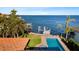 Aerial view showcasing the pool, lush backyard, and private dock with direct access to the expansive water at 2012 Carolina Ne Cir, St Petersburg, FL 33703