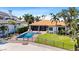 A beautiful backyard with a swimming pool, spa, and lovely landscaping surrounded by a fence for added privacy at 2012 Carolina Ne Cir, St Petersburg, FL 33703