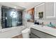 Modern bathroom with a walk-in shower, decorative window, and updated sink and vanity at 2012 Carolina Ne Cir, St Petersburg, FL 33703