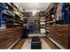 Walk-in closet with custom shelving, drawers, and soft lighting provides ample storage and organization at 2012 Carolina Ne Cir, St Petersburg, FL 33703