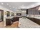 Open kitchen featuring stainless steel appliances, granite countertops, custom cabinets, and hardwood floors at 2012 Carolina Ne Cir, St Petersburg, FL 33703