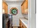 Laundry room with built-in cabinets, a utility sink, and octagonal window above the washer and dryer at 2012 Carolina Ne Cir, St Petersburg, FL 33703