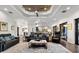 Spacious living room with hardwood floors, tray ceiling with fan, area rug, and comfortable seating at 2012 Carolina Ne Cir, St Petersburg, FL 33703