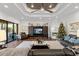 Spacious living room with a fireplace, tray ceiling with a fan, and glass doors to the outside at 2012 Carolina Ne Cir, St Petersburg, FL 33703