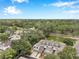 Aerial view of townhomes, showcasing a pond and lush trees surrounding the property in a serene neighborhood at 2531 Earlswood Ct, Brandon, FL 33510