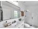 Bathroom with white vanity, black hardware, and glass enclosed shower with subway tile at 2531 Earlswood Ct, Brandon, FL 33510