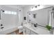 Updated bathroom with tub and shower, framed mirror, and modern fixtures at 2531 Earlswood Ct, Brandon, FL 33510