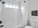 Bathroom featuring a tub shower, framed picture, and modern fixtures at 2531 Earlswood Ct, Brandon, FL 33510