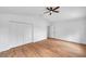 Bedroom features a ceiling fan, spacious closet, and hard wood floors at 2531 Earlswood Ct, Brandon, FL 33510
