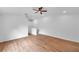 Bonus room with wood floors, ceiling fan, and stairway with white railing at 2531 Earlswood Ct, Brandon, FL 33510