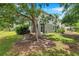 Exterior view of home featuring a screened in patio and lush landscaping at 2531 Earlswood Ct, Brandon, FL 33510