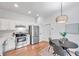Modern kitchen featuring stainless steel appliances, white cabinetry, and a cozy dining area at 2531 Earlswood Ct, Brandon, FL 33510