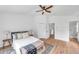 Bright bedroom features a ceiling fan, wood floors, and a convenient ensuite bathroom at 2531 Earlswood Ct, Brandon, FL 33510