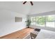 Relaxing bedroom with wood floors, ceiling fan, and natural light from a large window at 2531 Earlswood Ct, Brandon, FL 33510