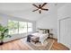 Inviting bedroom with wood floors, ceiling fan, natural light from window, and decor at 2531 Earlswood Ct, Brandon, FL 33510