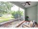 Relaxing screened-in patio featuring a ceiling fan and scenic water views at 2531 Earlswood Ct, Brandon, FL 33510