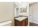 Bathroom with a single sink vanity, large mirror, and neutral walls at 256 Castlekeeper Pl, Valrico, FL 33594