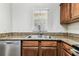 Updated kitchen featuring granite counters, stainless steel dishwasher, and a double basin sink at 256 Castlekeeper Pl, Valrico, FL 33594