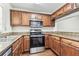 Kitchen with stainless steel appliances and wood cabinets at 256 Castlekeeper Pl, Valrico, FL 33594