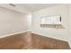 Open-concept living room featuring hardwood floors and a kitchen pass-through at 256 Castlekeeper Pl, Valrico, FL 33594
