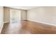 A bright living room featuring hardwood floors and a sliding glass door at 256 Castlekeeper Pl, Valrico, FL 33594
