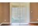 Living room featuring hardwood floors and sliding glass door with vertical blinds at 256 Castlekeeper Pl, Valrico, FL 33594