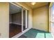 View of a screened patio featuring green carpet and sliding glass door to the living room at 256 Castlekeeper Pl, Valrico, FL 33594