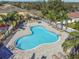Aerial view of the clover shaped community pool and surrounding houses with mature landscaping at 256 Castlekeeper Pl, Valrico, FL 33594