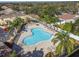 Aerial view of the clover shaped community pool and surrounding houses with mature landscaping at 256 Castlekeeper Pl, Valrico, FL 33594