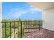 A spacious balcony with brick flooring offers expansive water views and iron railings at 2699 Seville Blvd # 705, Clearwater, FL 33764