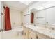 Bathroom features a shower-tub combo and marble countertops at 2699 Seville Blvd # 705, Clearwater, FL 33764