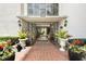 The building entrance features a brick walkway, plants, and glass doors to the interior at 2699 Seville Blvd # 705, Clearwater, FL 33764