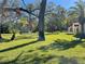 Expansive green lawn with mature trees surrounding the home at 2699 Seville Blvd # 705, Clearwater, FL 33764