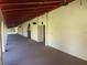 Outdoor hallway featuring concrete floors, arches, and lighting at 2699 Seville Blvd # 705, Clearwater, FL 33764