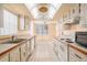 Clean and organized kitchen space with white cabinetry, appliances, and tile flooring at 2699 Seville Blvd # 705, Clearwater, FL 33764