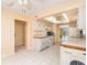 Efficient kitchen layout with standard appliances, ample counter space, and tile floors at 2699 Seville Blvd # 705, Clearwater, FL 33764