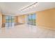 Spacious living room with tile flooring, large windows, and sliding glass doors at 2699 Seville Blvd # 705, Clearwater, FL 33764