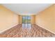 A vacant living room with unique wood floors awaits your personal touch and style at 2699 Seville Blvd # 705, Clearwater, FL 33764