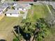 An aerial view of a white house and garage surrounded by grass and trees at 318 Banana St, Tarpon Springs, FL 34689