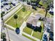 Bird's eye view displays a meticulously kept home, yard, and garage, set against a backdrop of lush greenery and neighborhood streets at 318 Banana St, Tarpon Springs, FL 34689