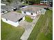 Aerial view showcases a white home with detached garage and ample yard space at 318 Banana St, Tarpon Springs, FL 34689