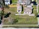 Aerial view displays houses with a lush yard and nearby street access at 318 Banana St, Tarpon Springs, FL 34689