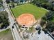 An aerial view of a well-maintained baseball field surrounded by trees at 318 Banana St, Tarpon Springs, FL 34689