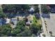 A bird's eye view showcases a well-manicured yard, mature trees, and neighborhood streets, offering a glimpse of the community at 318 Banana St, Tarpon Springs, FL 34689